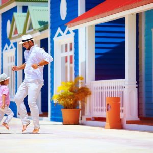 happy father and son enjoy life, dancing on caribbean street